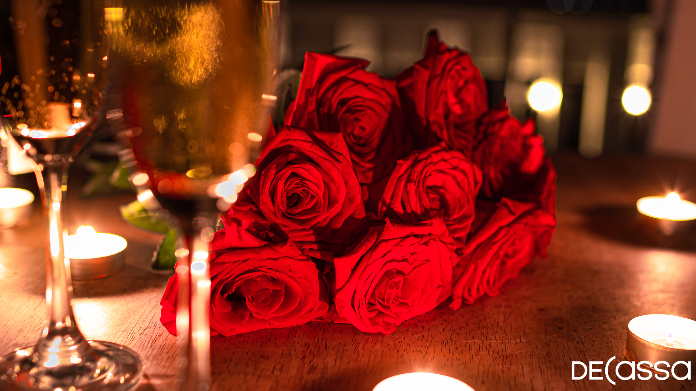 A bouquet of Roses on a Dining table with two champagne glasses
