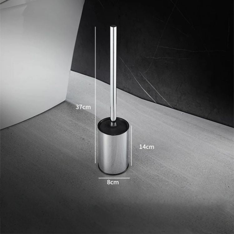 Gold toilet brush holder with brush resting on top, styled in a white bathroom setting.