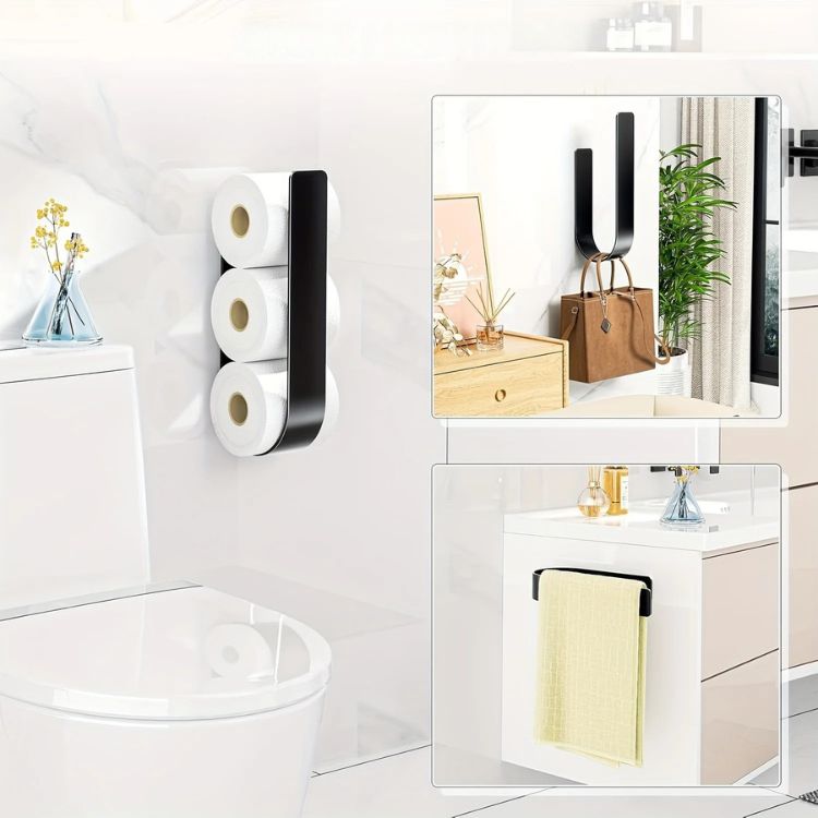 A black wall-mounted toilet paper rack holding three rolls