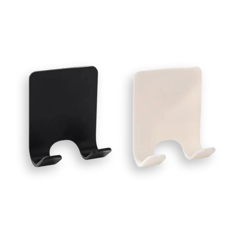 A black adhesive razor holder holding a razor, mounted on a white wall.