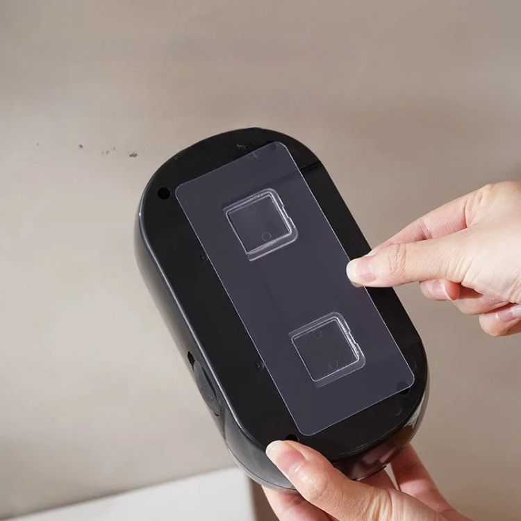 Mounting a black sensor soap dispenser.
