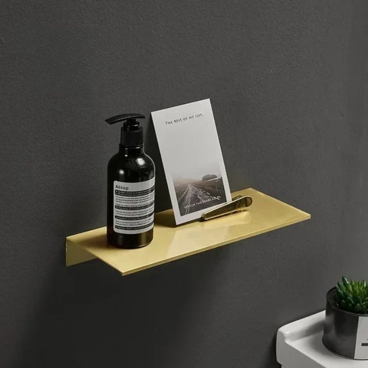 Brushed floating wall shelf beside sink with soap dispenser and toothbrushes.