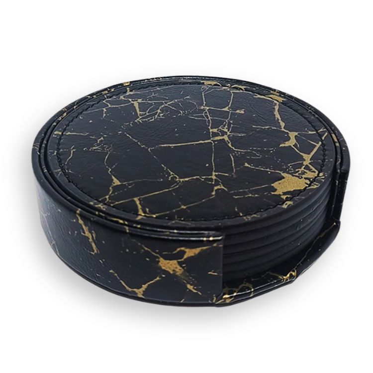 Stack of round black drink coasters with gold marble veining in a matching holder.