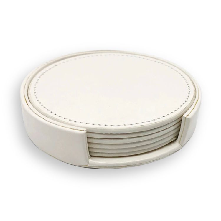 Set of plain white drink coasters in a round holder with stitched edges.