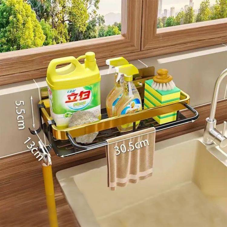 Golden sink drain rack with supplies and towel.