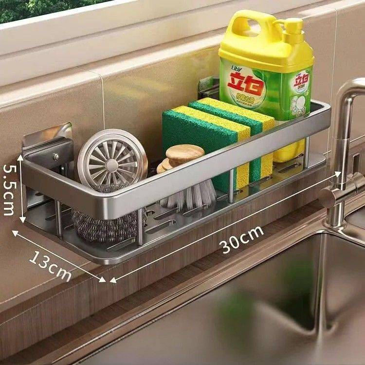 Compact sink drain rack with sponges and bottle.
