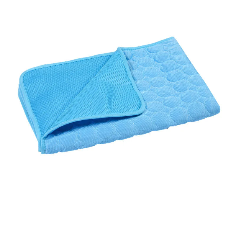 Bright blue folded dog cooling mat on white background.
