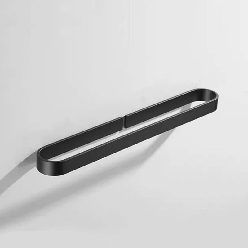 Minimalist black kitchen towel rack mounted on a white wall.