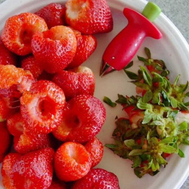 Close-up showing fruit corer removing strawberry stem.