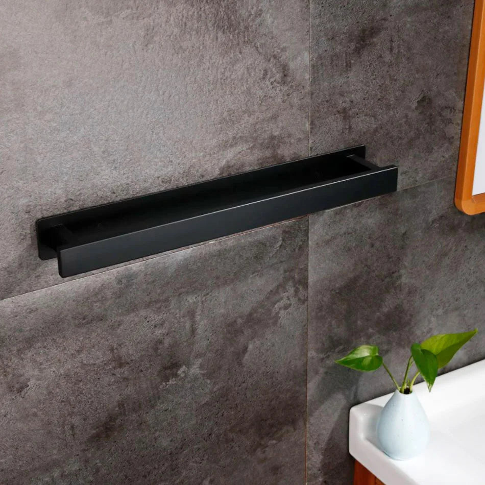 Black self adhesive towel rail mounted on a grey bathroom wall.