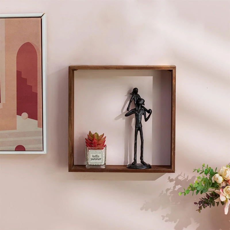 Iron figurine displayed on wooden wall shelf.