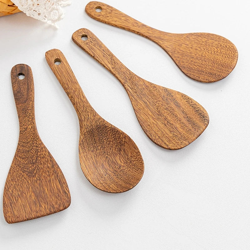 Set of four wooden kitchenware utensils arranged on a lacy tablecloth.