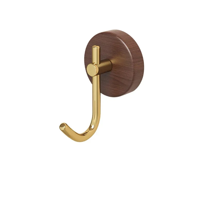 Wooden coat hook with a gold-colored metal arm.