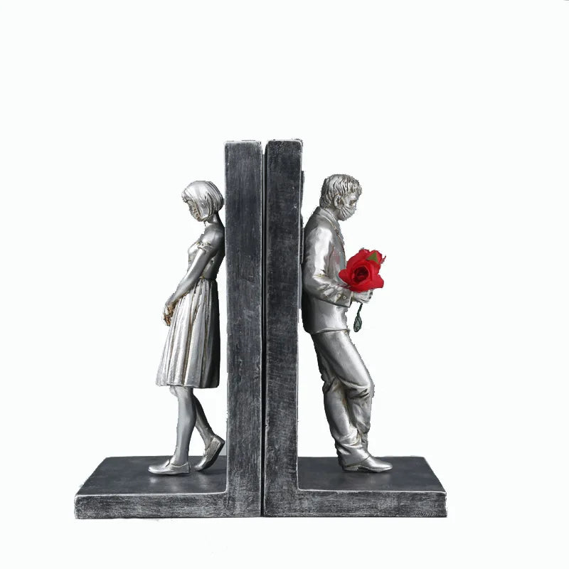 Silver book stand with two figures.