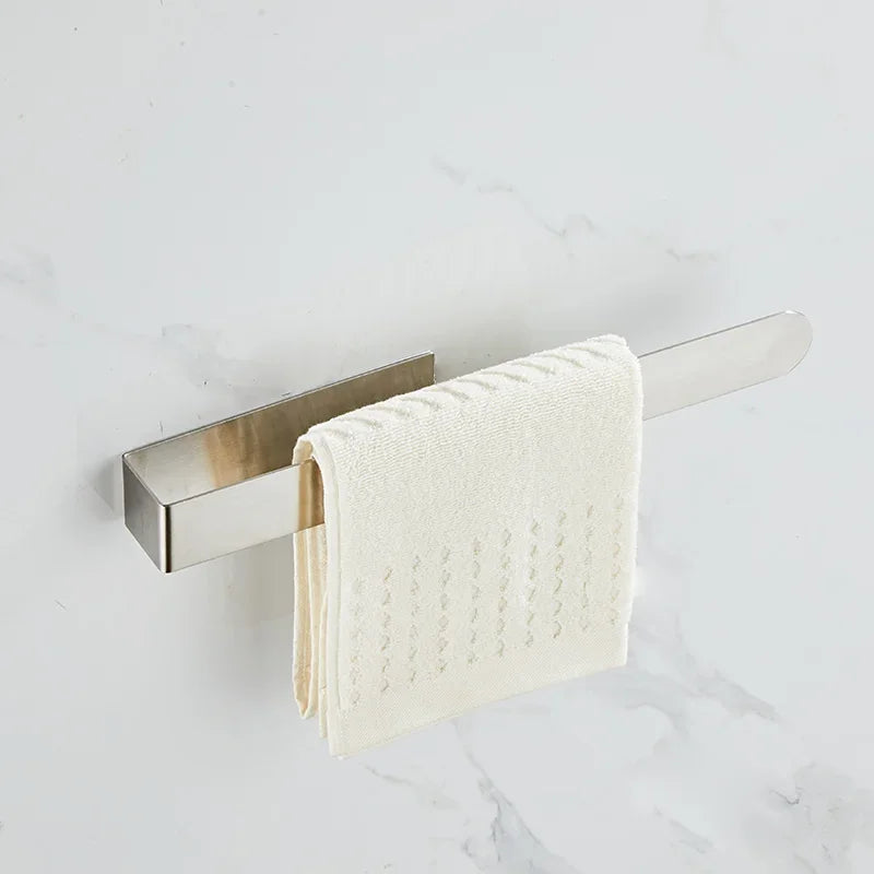 Minimal silver adhesive towel ring with white cloth.