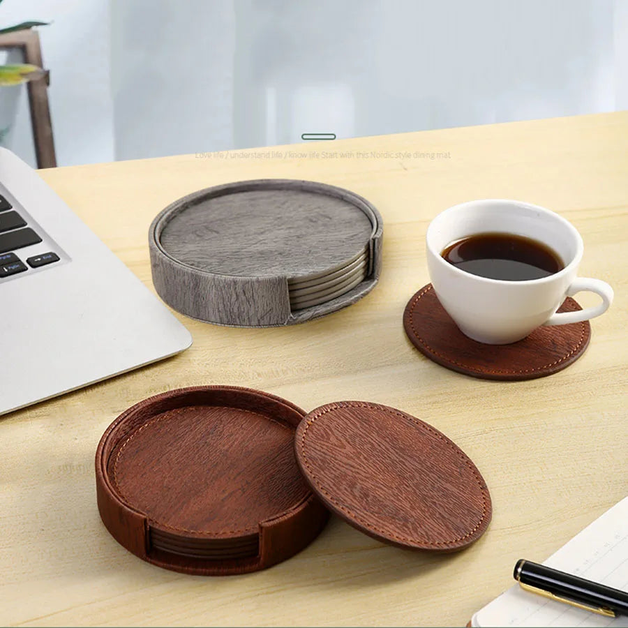 Gray and brown coasters tea with a cup on a desk.