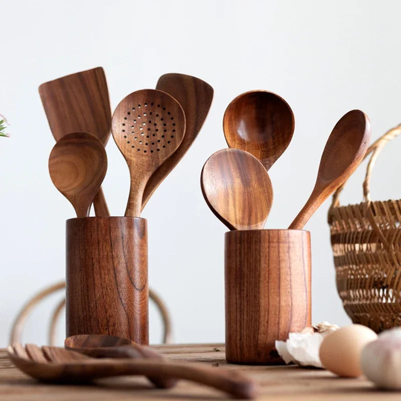 Wooden kitchenware set laid flat with spoons and spatulas.