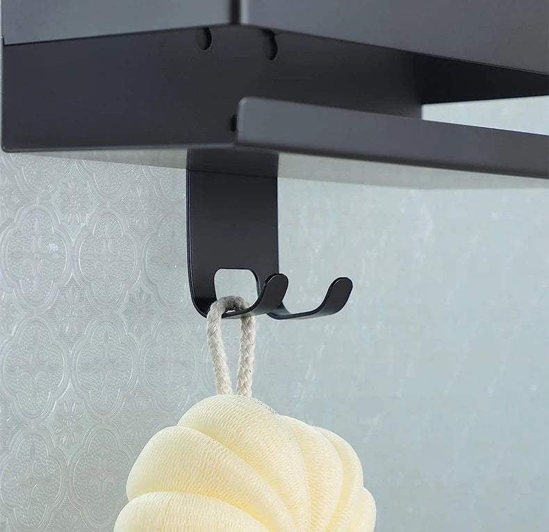 Close-up of shower shelf hook holding bath sponge.