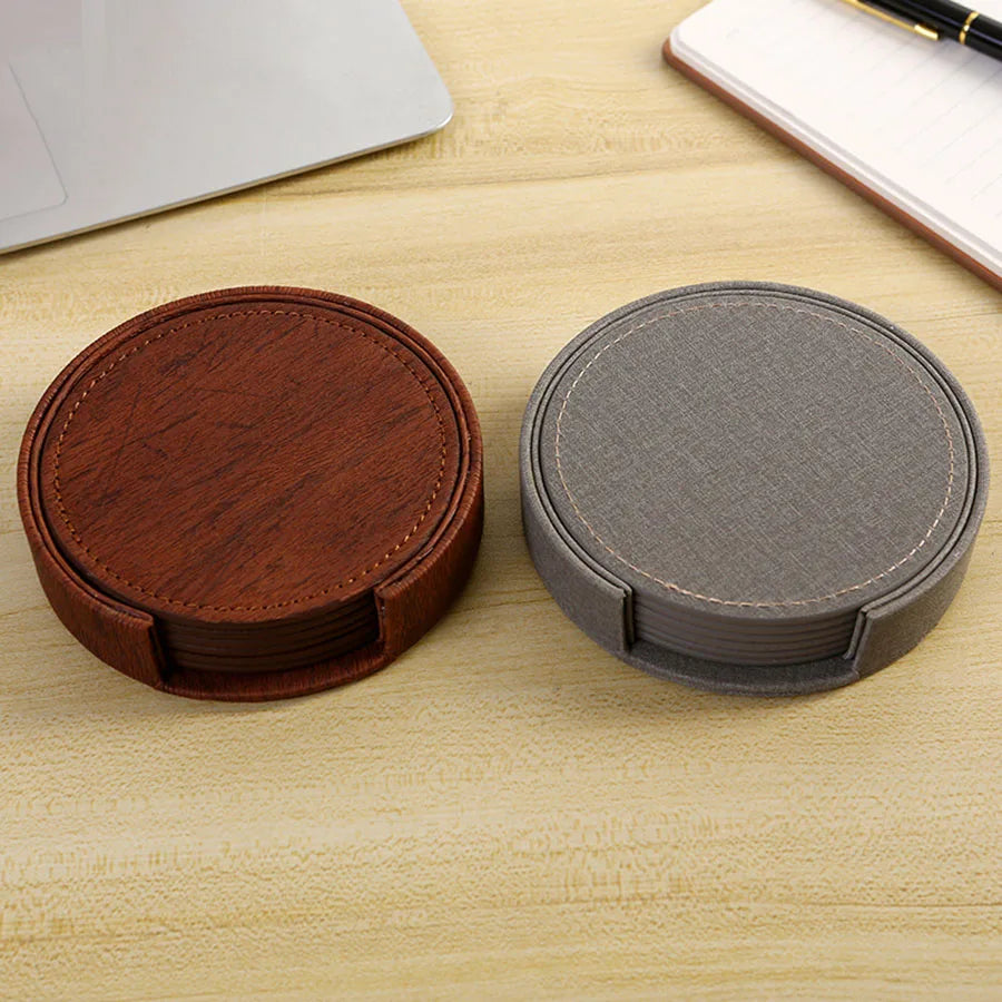 Gray and brown coasters tea on desk side by side.