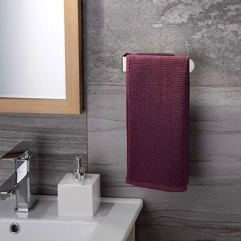 Wall-mounted adhesive towel ring with purple towel.