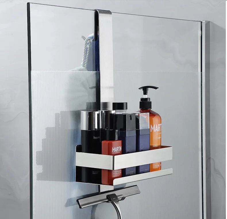 White shower shelf filled with bottles on shower wall.