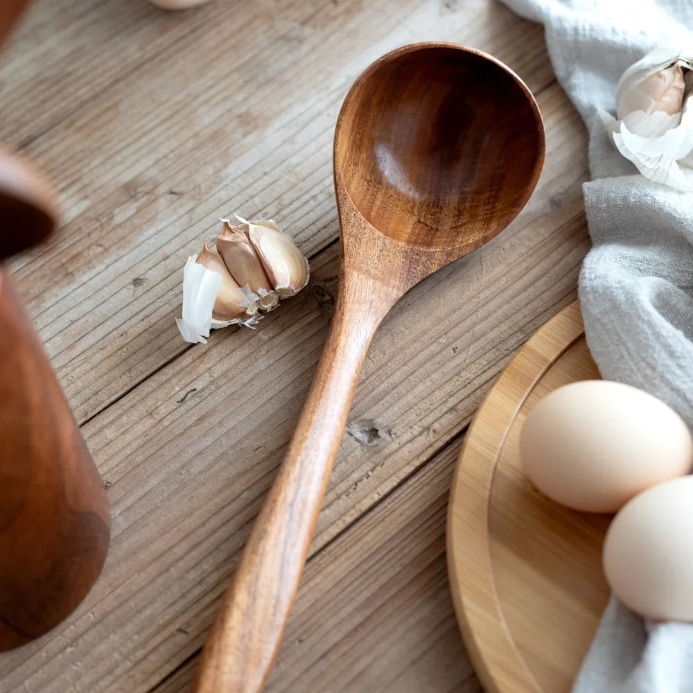 Wooden kitchenware set with eggs and garlic.