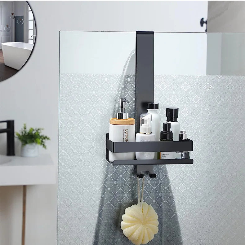 Black shower shelf holding bottles, sponge hanging below.