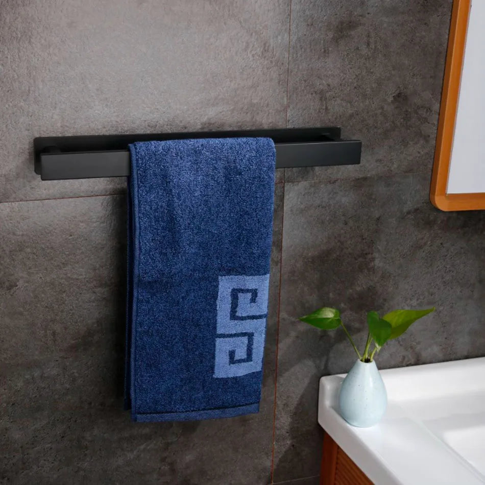 Black self adhesive towel rail with blue towel, mounted near sink.