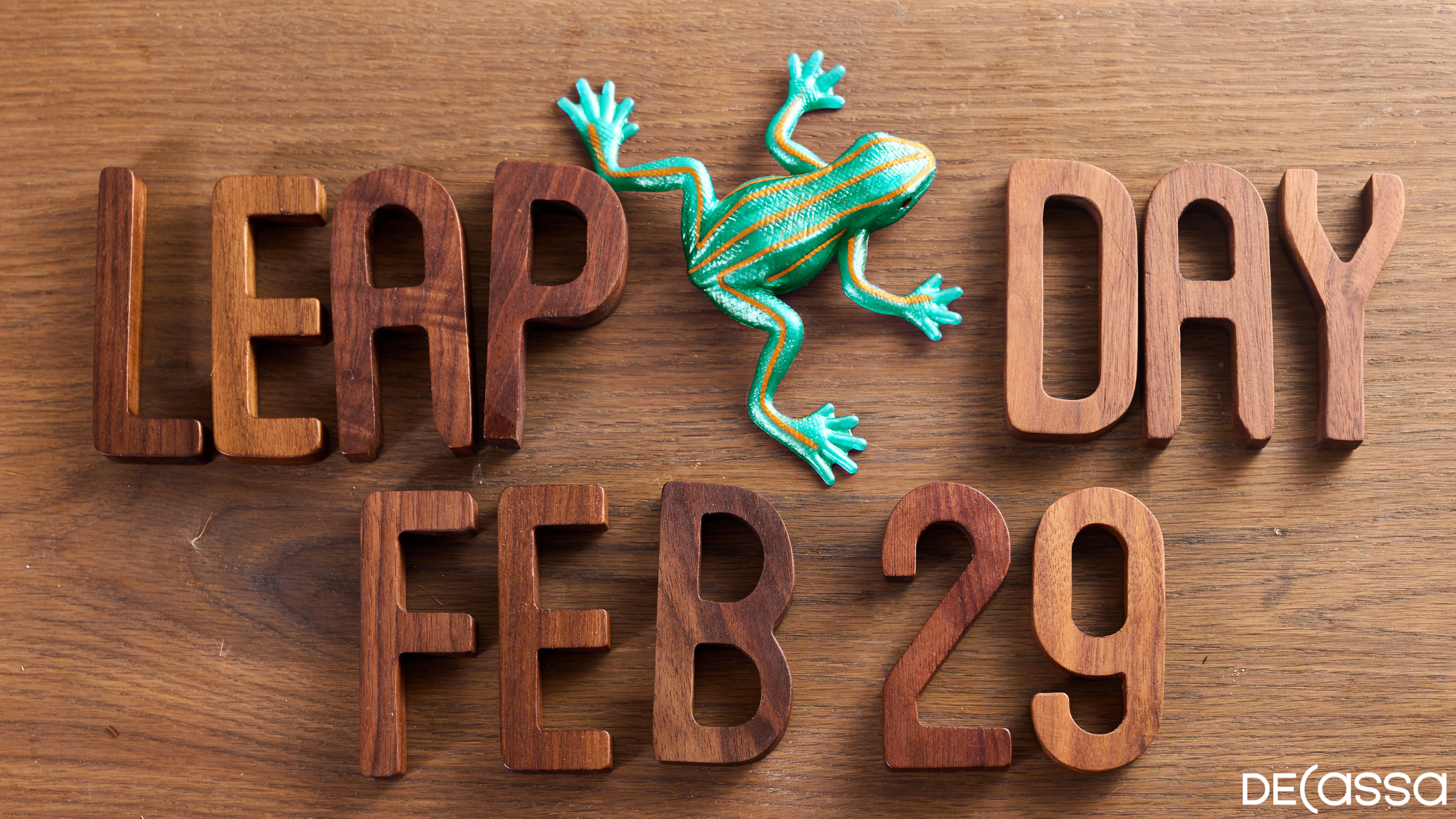 Wooden Letters which Say Leap Day February 29 with a green dart frog