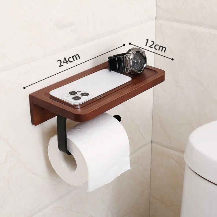 A wooden toilet paper holder with a small shelf, holding a roll of toilet paper.