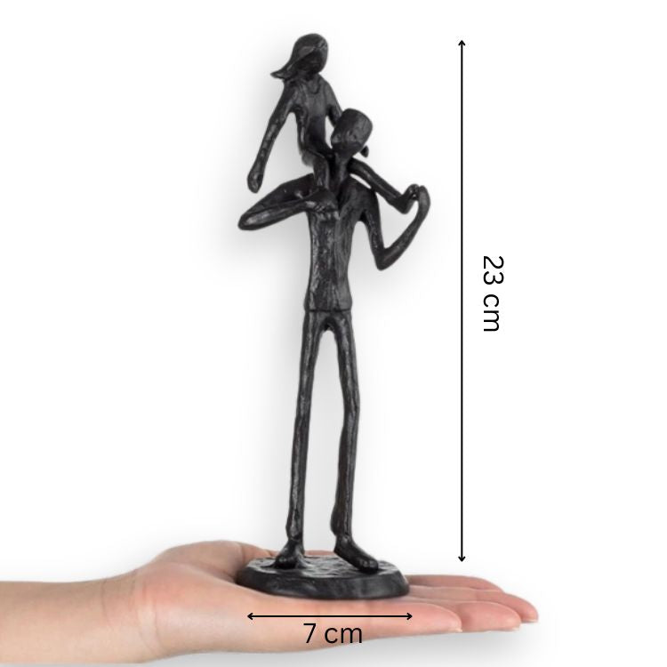 Iron figurine held in hand showing size scale.