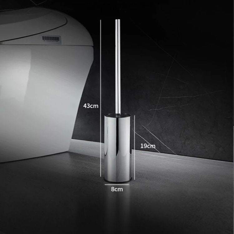 Chrome toilet brush holder with brush standing upright beside toilet.