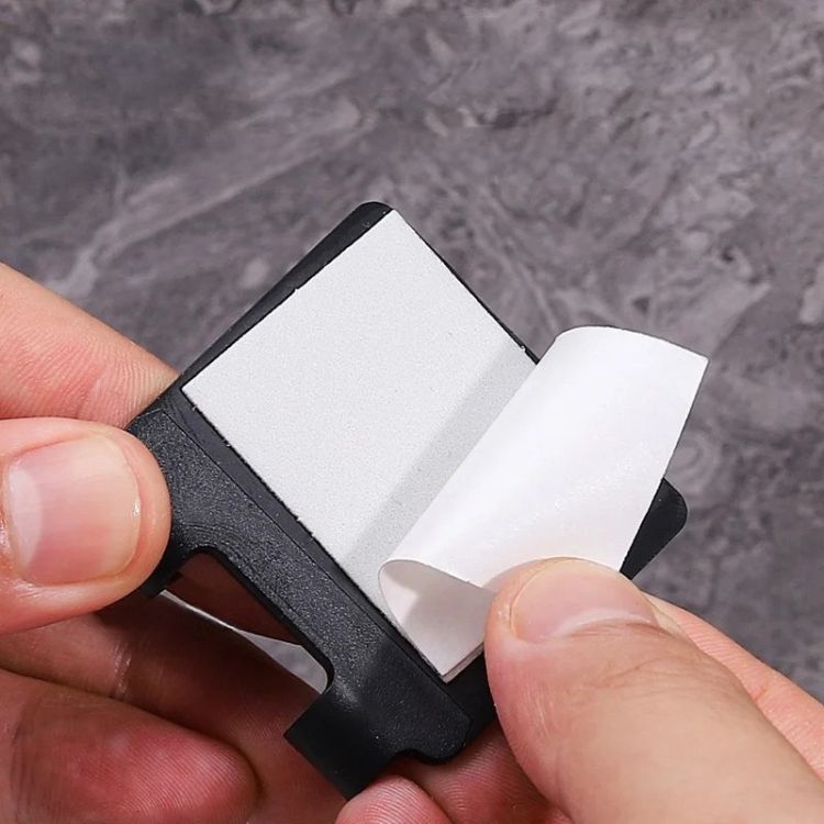 A black razor holder on a black background, emphasizing its design.
