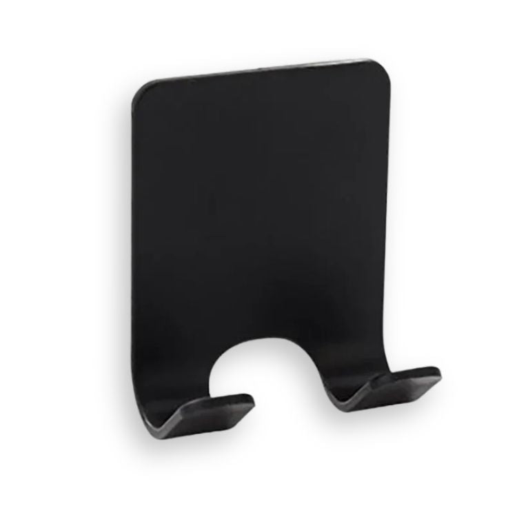  A close-up of a black adhesive razor holder on a white surface.