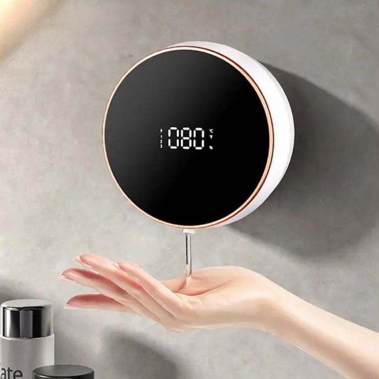 A white smart soap dispenser with a rose gold trim and digital display