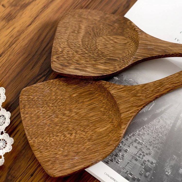 Close-up of wooden spatulas laid out in a fan pattern.