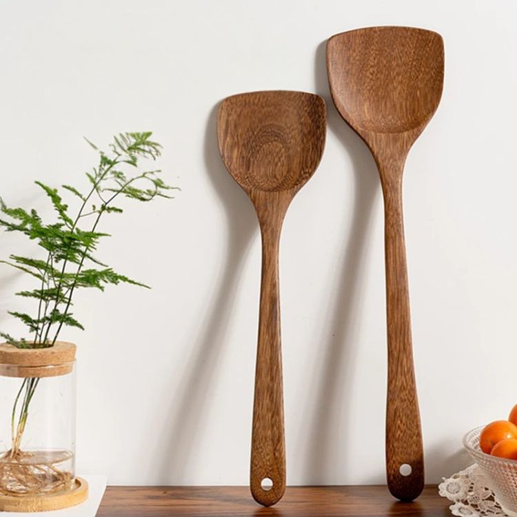 Wooden kitchen tools displayed standing on a kitchen counter.