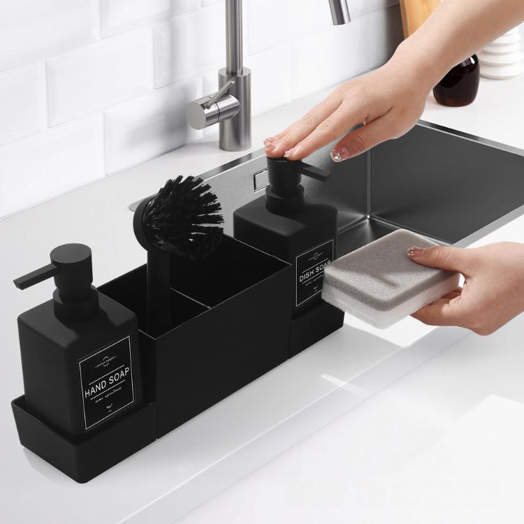 Person placing sponge into black sink caddy.