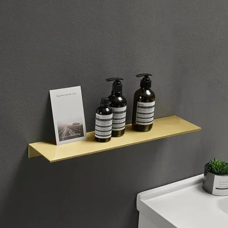 Brushed floating wall shelf with hand soap and diffuser beside a sink.
