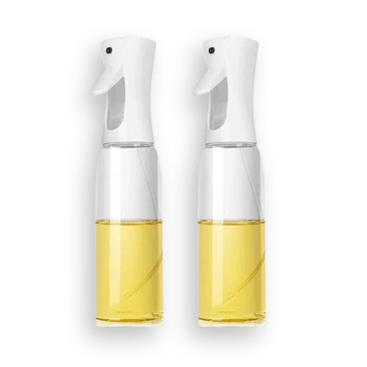 Pair of white oil sprayer bottles with wider bases filled with oil.