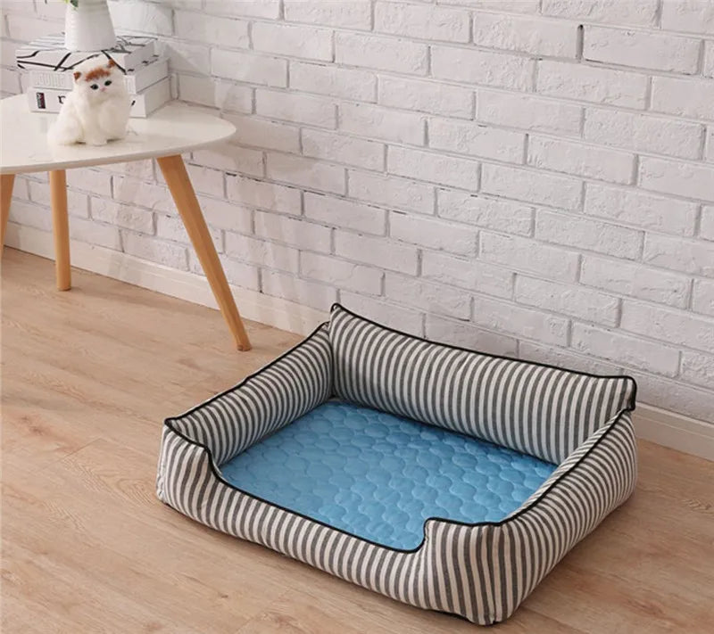Dog cooling mat placed inside a striped dog bed.
