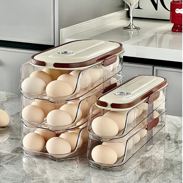 Double egg rack for fridge with cream lids, stacked and filled with eggs on a kitchen counter.