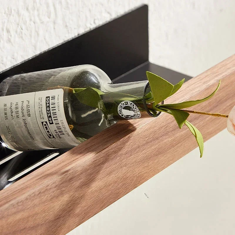 Close-up of a floating wood shelf holding a wine bottle.