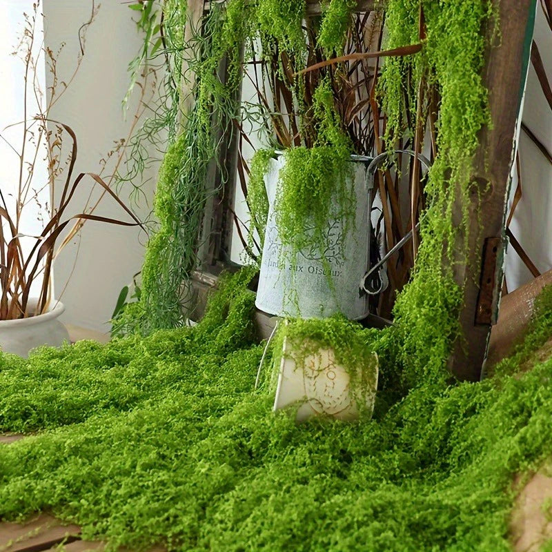 Rustic display with fake moss draped over wooden frames and containers.