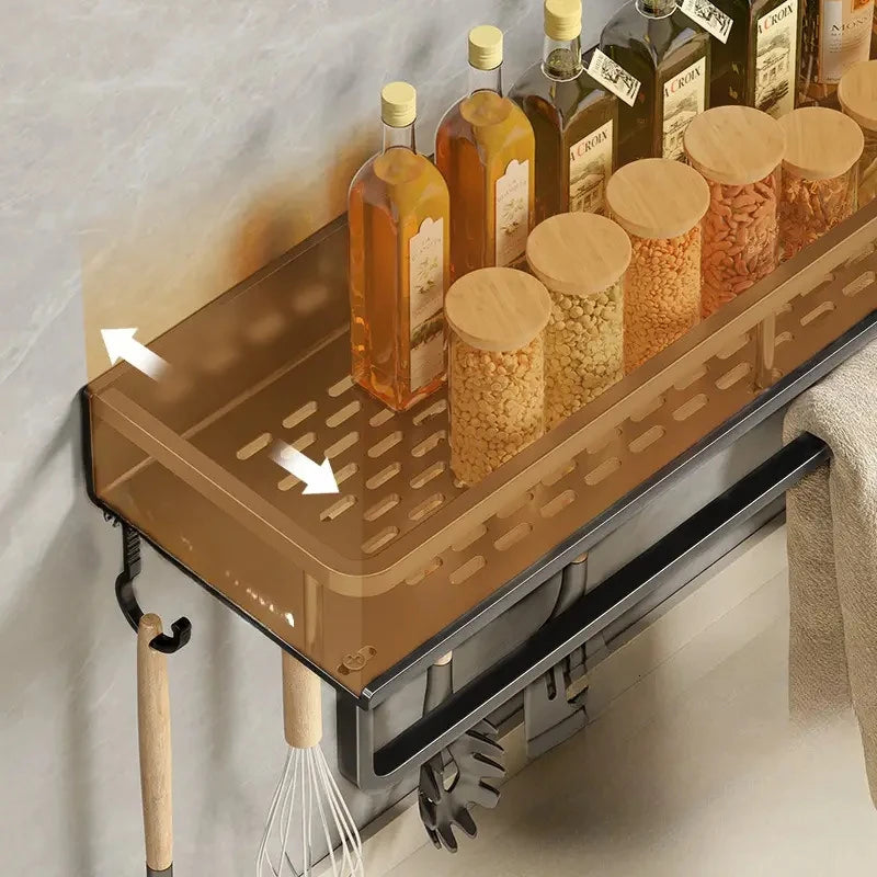 Wall-mounted gold spice rack organizer with arrows indicating airflow or drainage.
