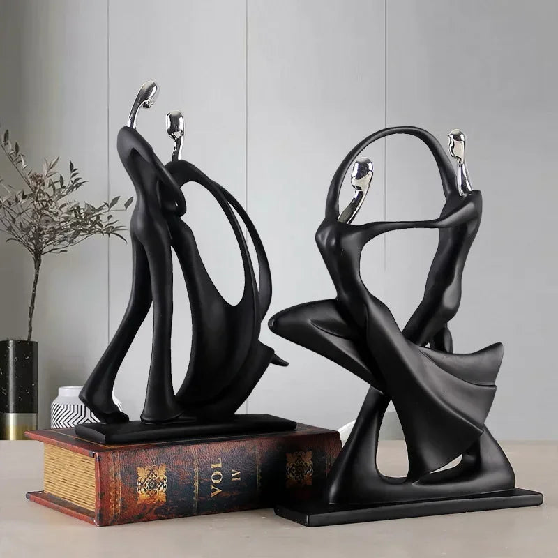 Black dancing figurine on a book.