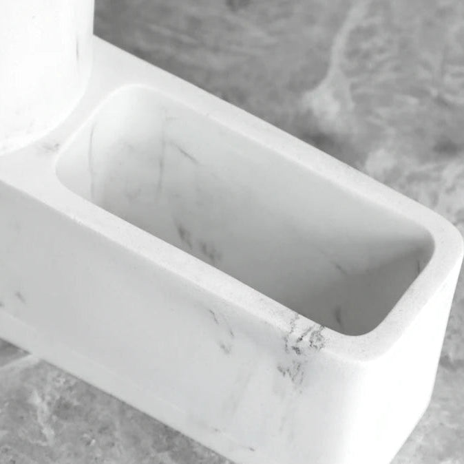 Close-up of white marble sponge holder compartment from dispenser.