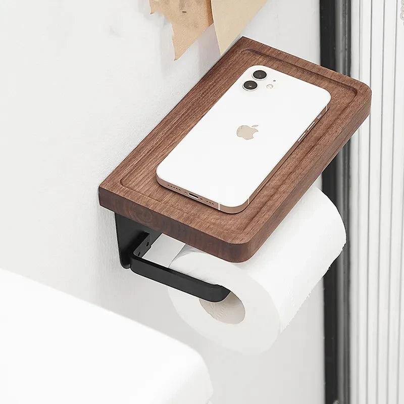 A wooden toilet paper holder with a black U-shaped arm, holding a roll of toilet paper.