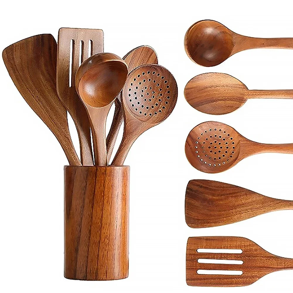 Wooden kitchenware set in a holder on a grey background.