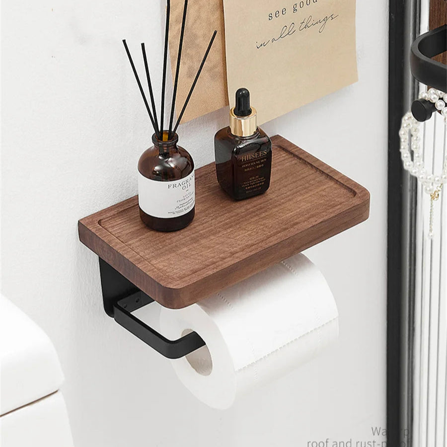 A wooden toilet paper holder mounted on a wall, holding a roll of toilet paper.